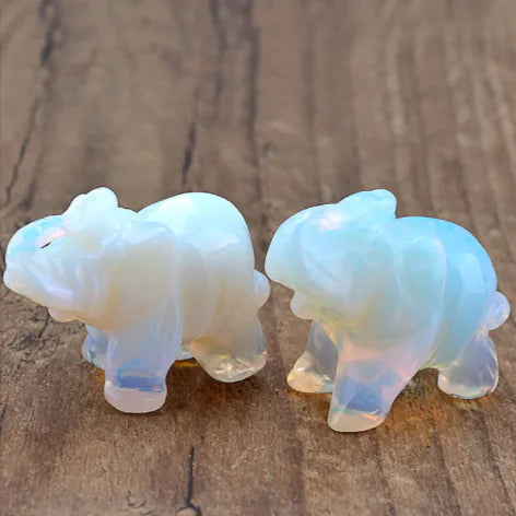 Two iridescent bear figurines on a wooden surface