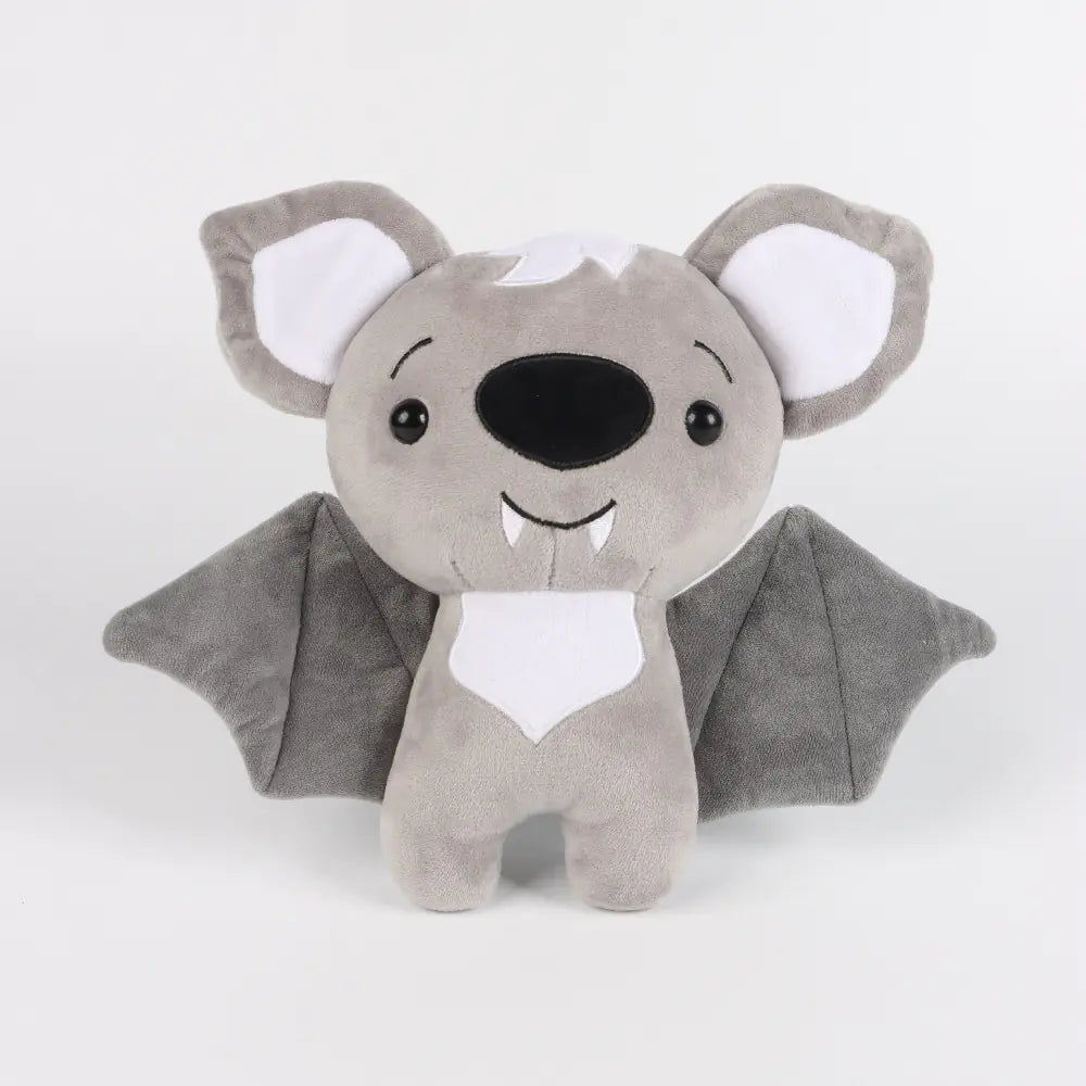 Plush toy bat with gray wings and white face on a light gray background