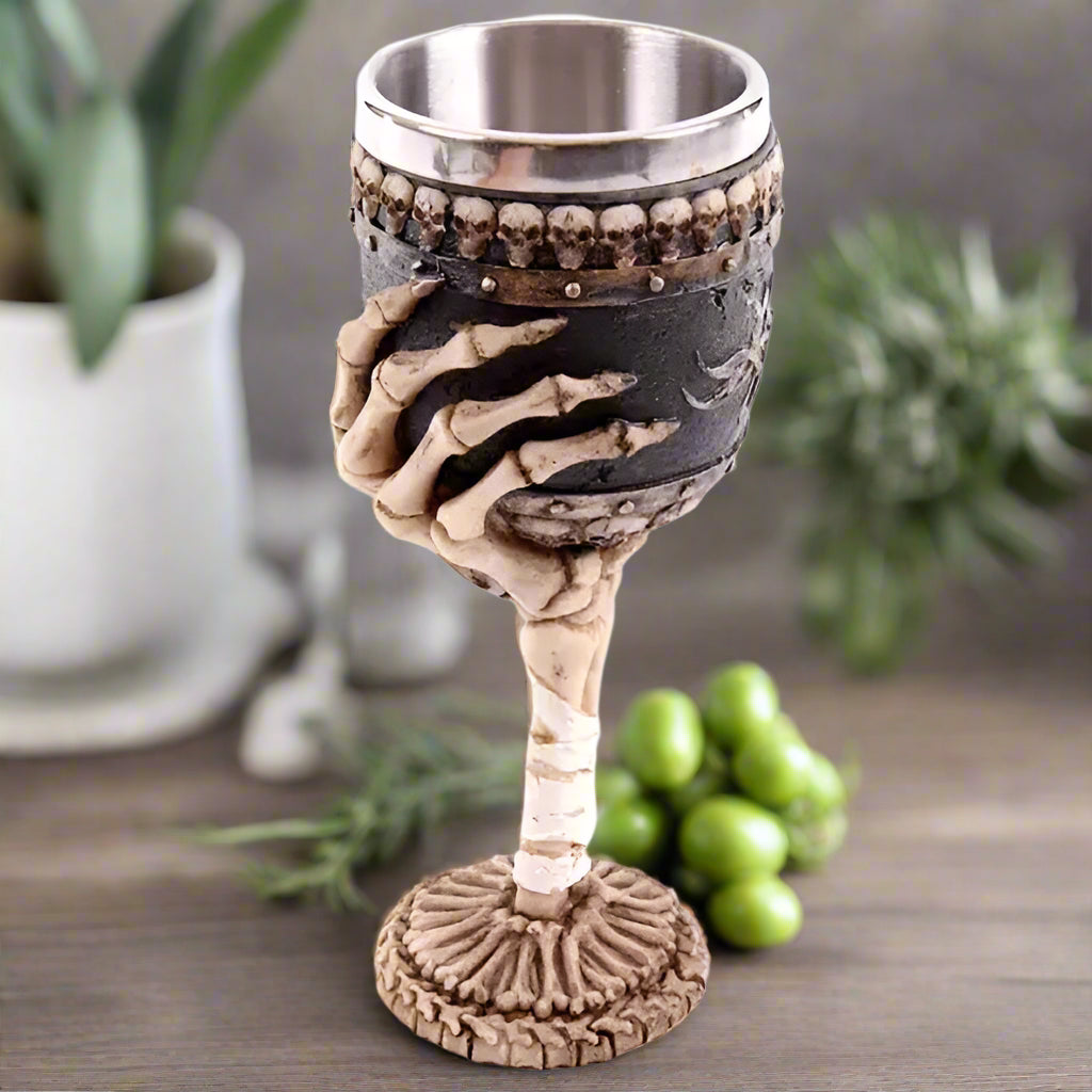 Gothic-style goblet with skeleton hand design on a white background