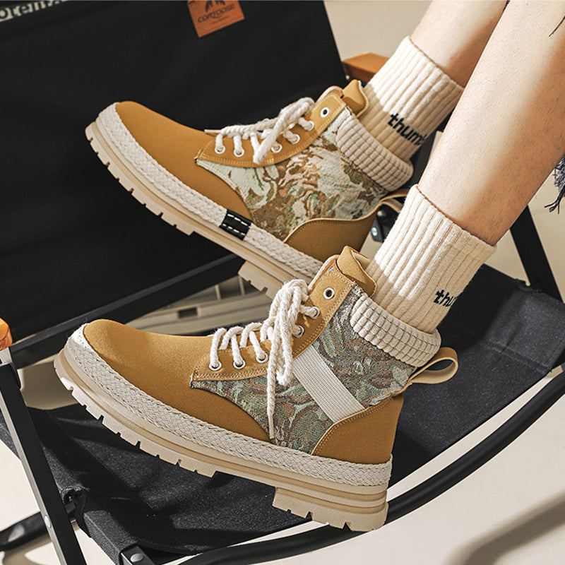 Brown and beige camouflage sneakers worn with white socks on a chair.