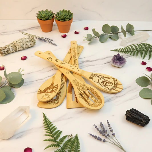 Set of wooden spoons with engraved designs on a light background
