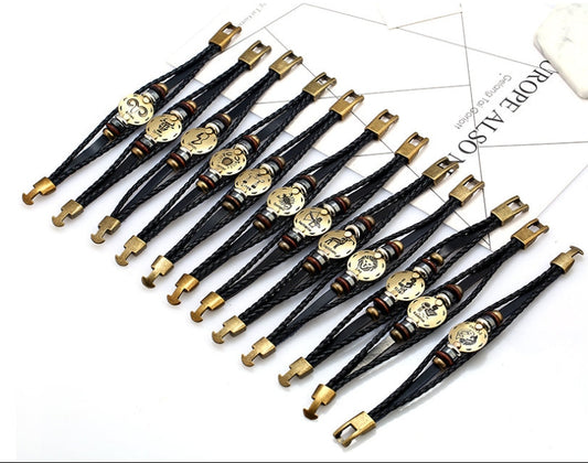 Set of black and gold bracelets on a white background