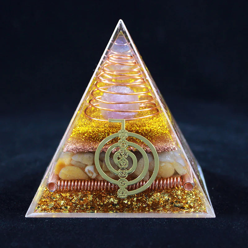Pyramid-shaped object with a spiral design and decorative elements on a dark background