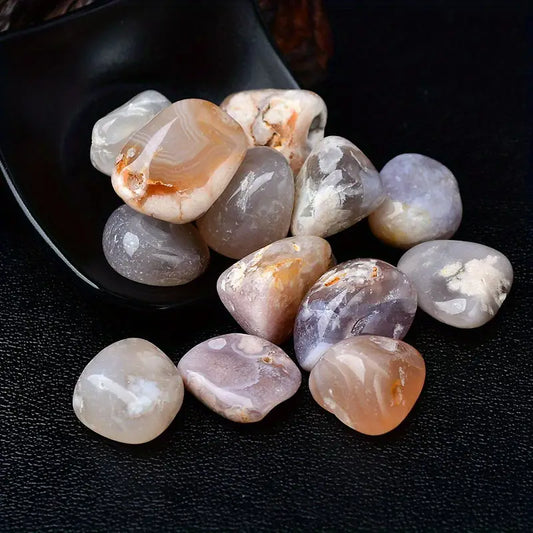 Collection of polished gemstones on a dark surface