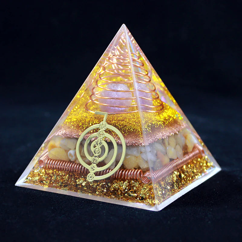 Pyramid-shaped crystal with decorative elements on a dark background