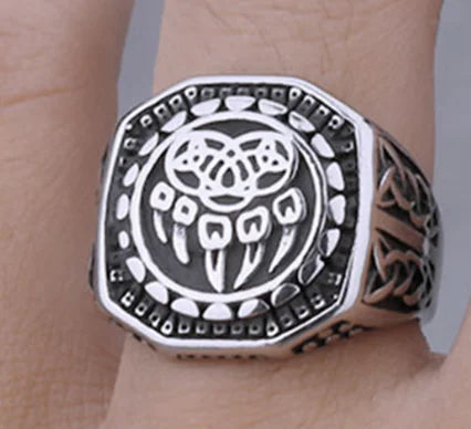 Silver ring with intricate design on a wrist