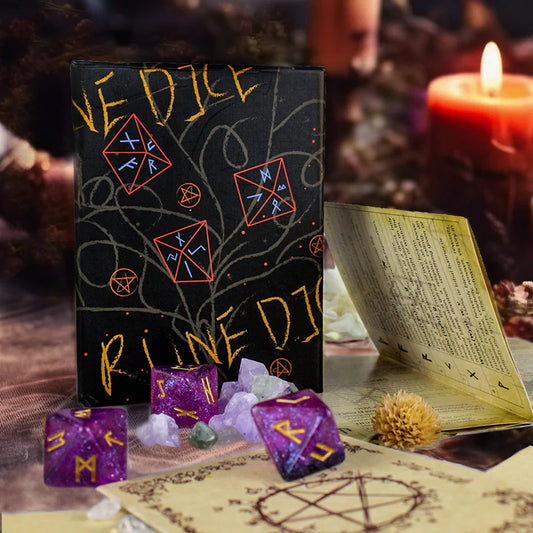 Black dice set with purple dice and mystical symbols on a table with candles and an open book.