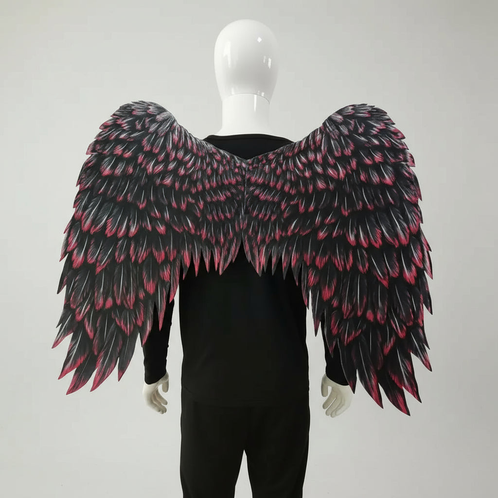 Black and pink feathered wings on a mannequin against a white background