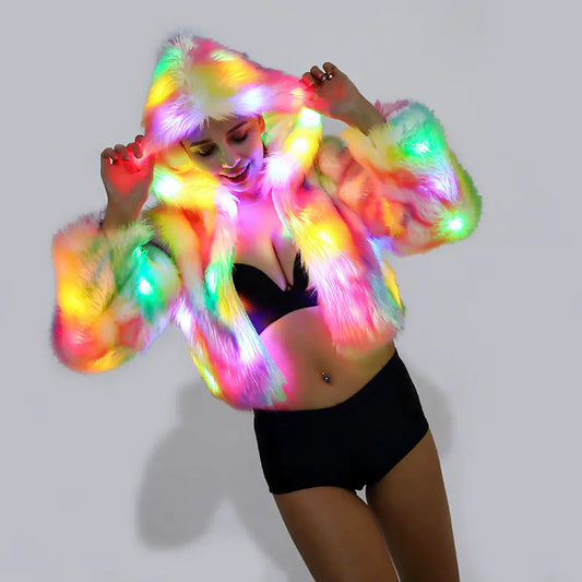 Person wearing a colorful, illuminated led fur coat against a plain background