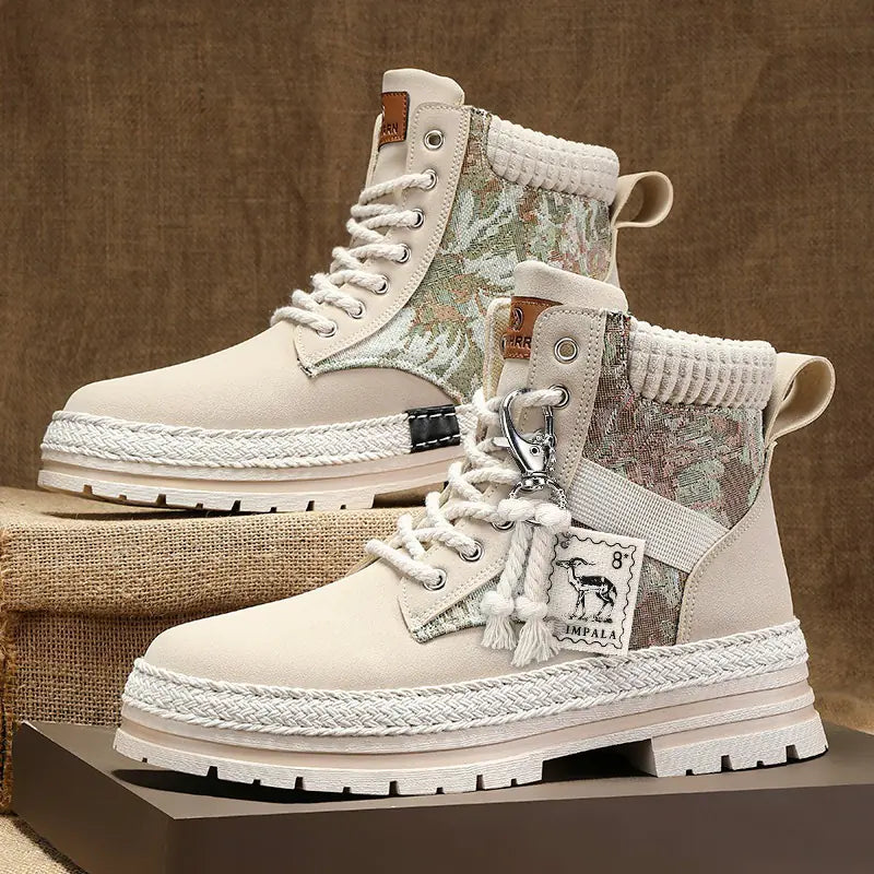 Pair of beige and floral-patterned boots on a textured surface with a brown background