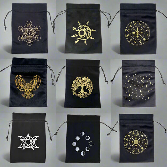 Set of black drawstring bags with gold and white symbols on a white background