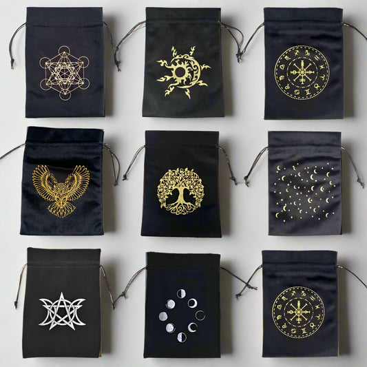 Black drawstring bags with gold and white symbols on a light gray background