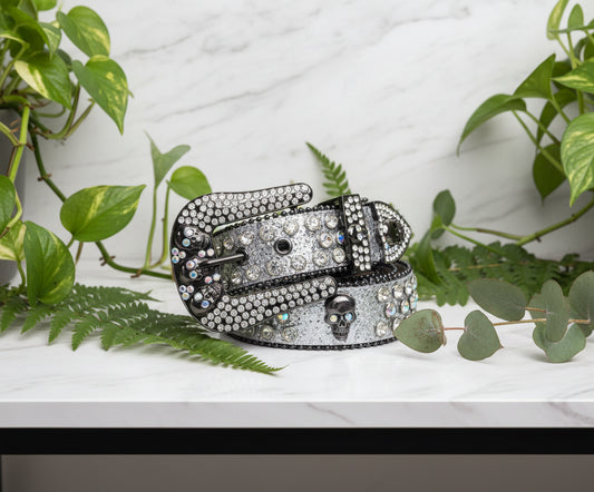 Decorative belt with rhinestone buckle and skull design on a white background