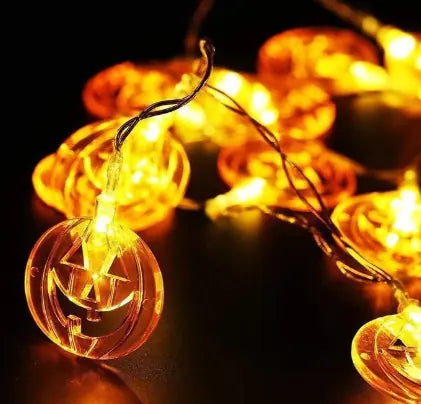 String lights with pumpkin design on a dark background