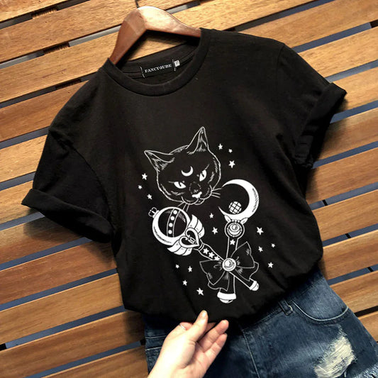 Black t-shirt with a cat and moon design on a wooden surface
