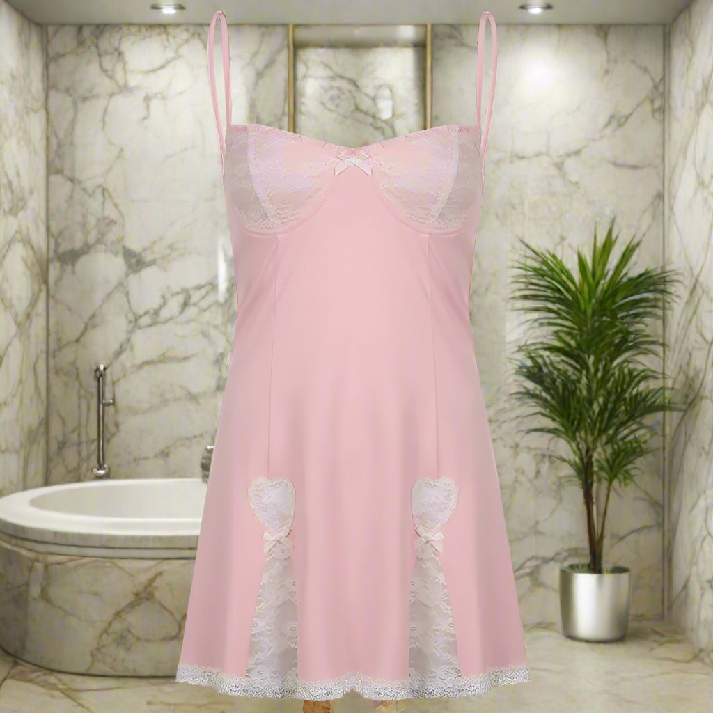 Pink slip dress with lace details on a white background