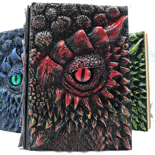 Notebook with dragon design on cover, surrounded by other similar notebooks.