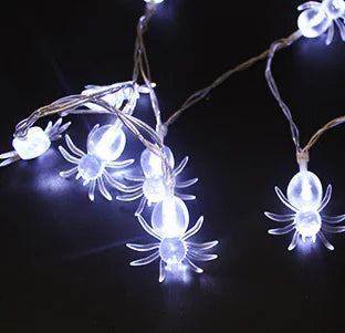 String lights shaped like spiders on a dark background
