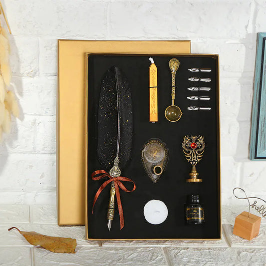Decorative set with a feather pen, candles, and other items in a black box on a white brick wall background.