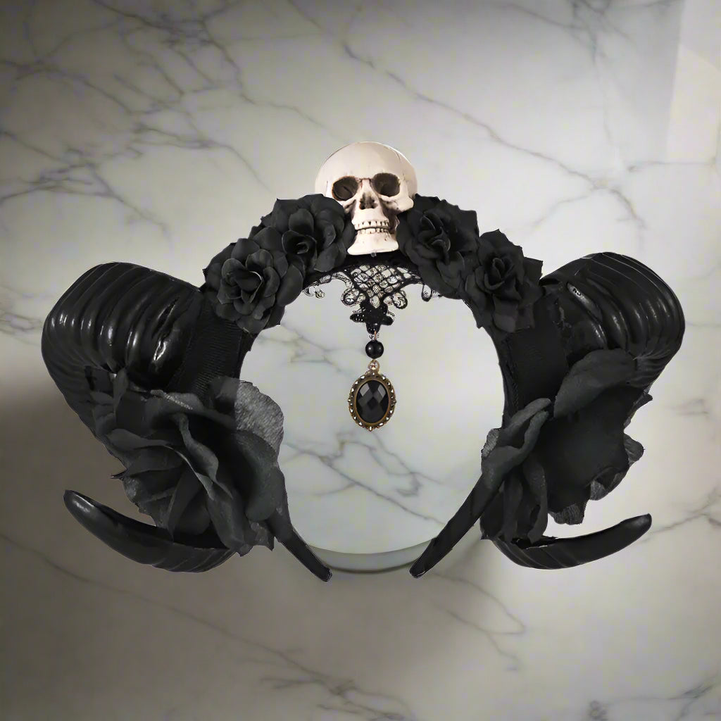 Gothic-style headband with black roses and skull design on a white background