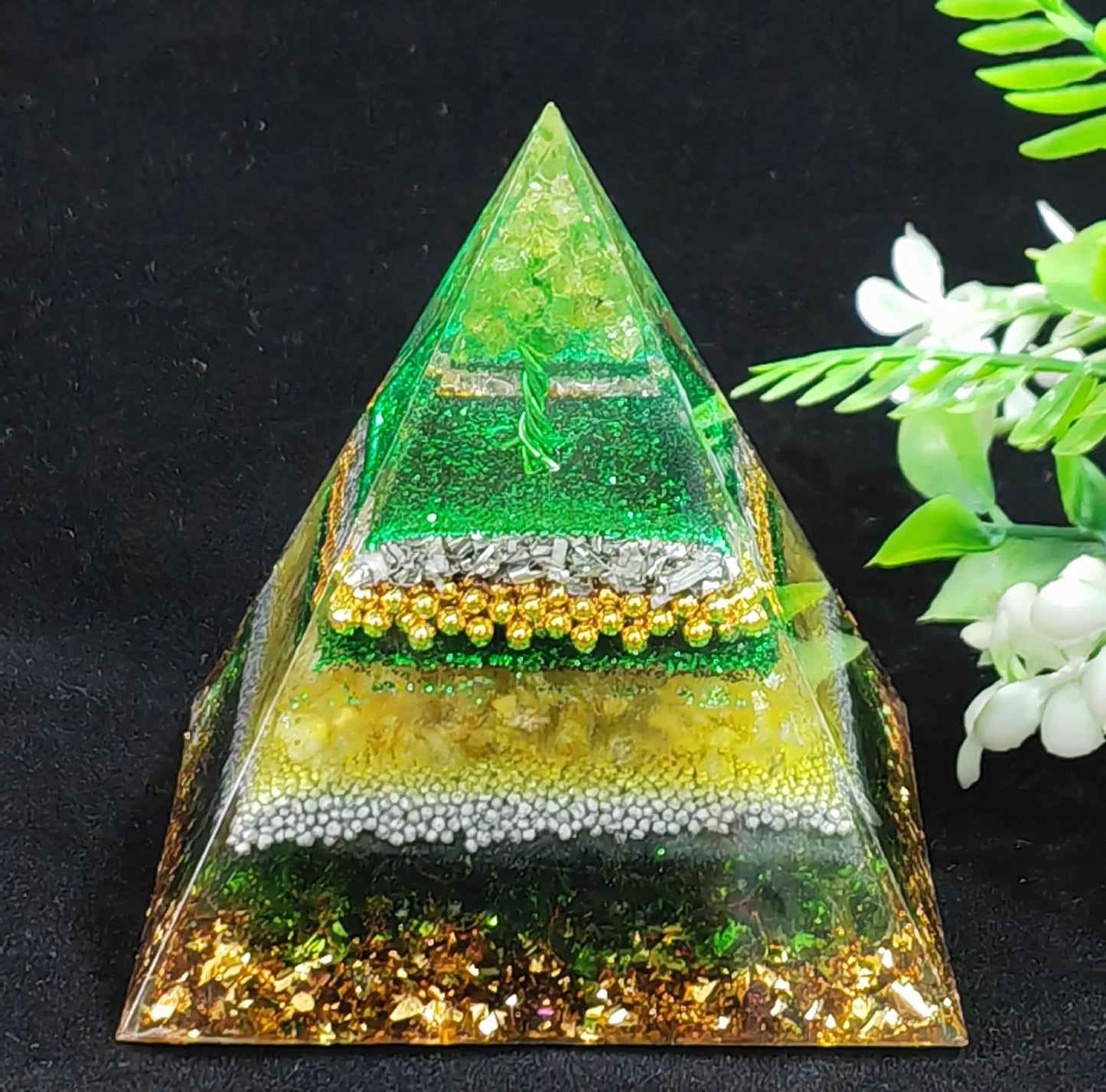 Pyramid-shaped object with layered design on a black background