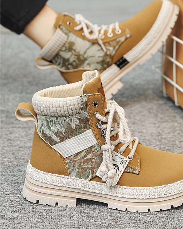 Camouflage-patterned boots with brown and beige accents on a gray surface, with an IKEA box in the background.