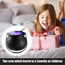 Child opening a gift with a witch barrel decoration on a bed.