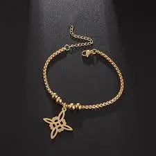 Gold bracelet with a star-shaped charm on a dark background