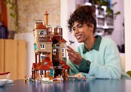 Person playing with a detailed toy castle set indoors