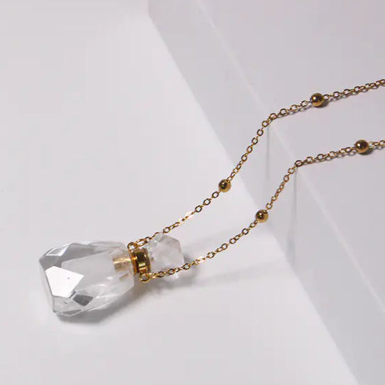 Crystal necklace with gold chain on a white background