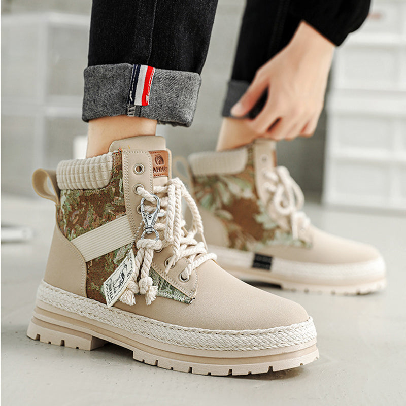 Beige and camouflage hiking boots with decorative laces on a neutral background