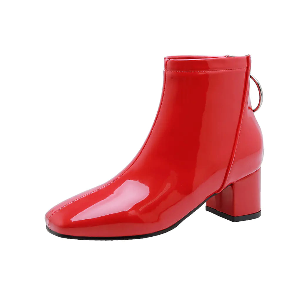 Shiny red ankle boot with a block heel on a white background
