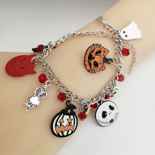 Bracelet with Halloween-themed charms on a wrist against a light background