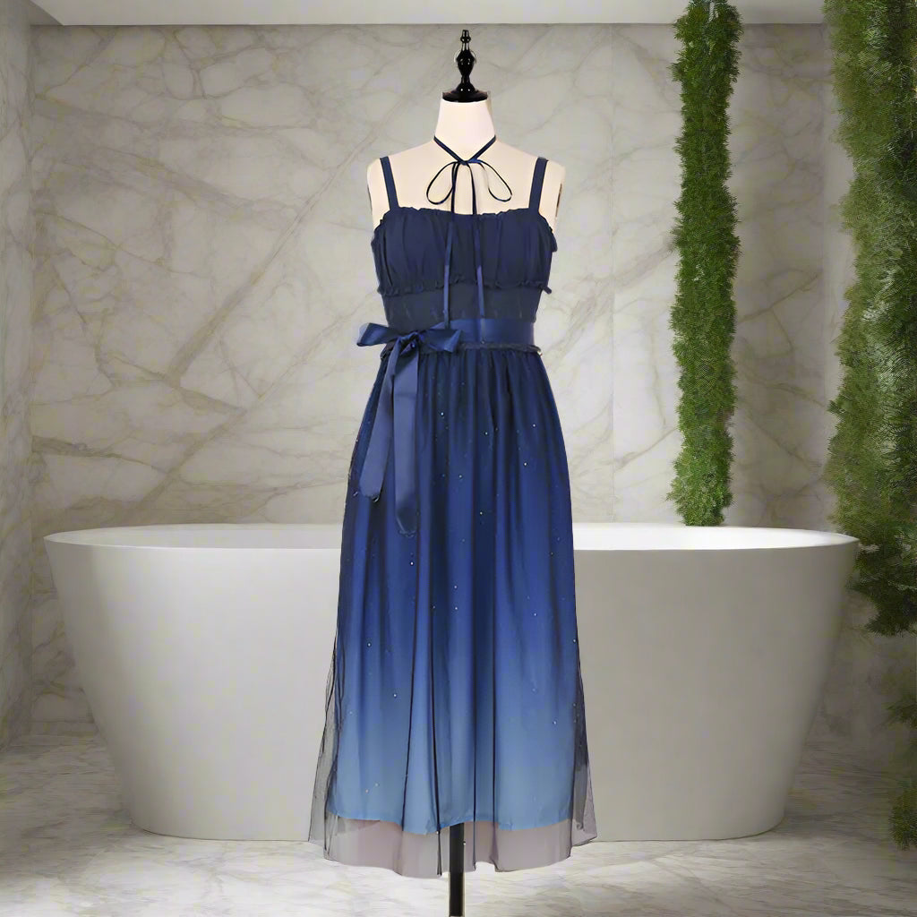 Blue gradient dress on a mannequin against a striped background