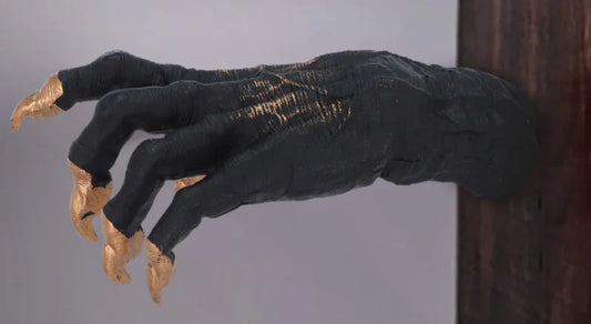 Black glove with gold accents on a plain background