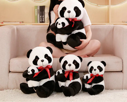 Woman holding a set of panda plush toys in a cozy living room.