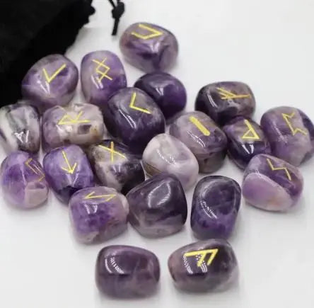 Purple stones with yellow runes on a white background