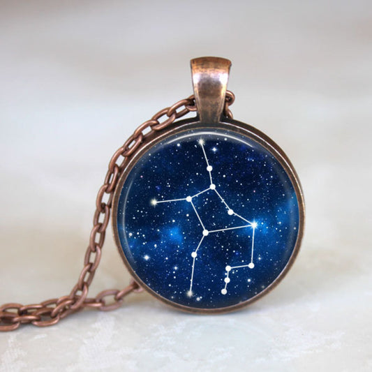 Necklace with a pendant featuring a star constellation design on a blue background.