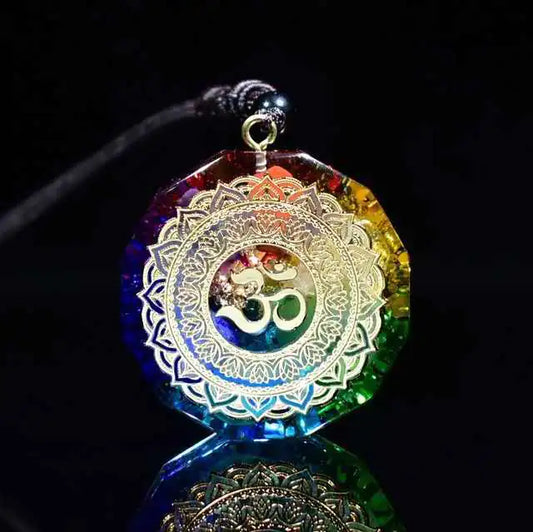 Multicolored pendant with Om symbol on a black background