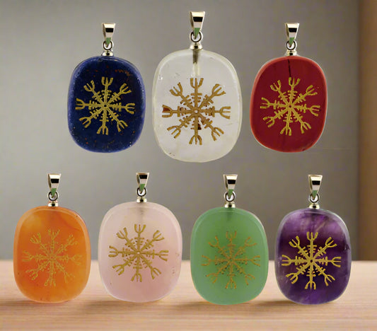 Set of seven stone pendants with gold snowflake designs on a white background