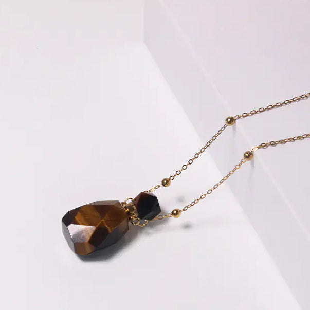 Necklace with a tiger eye stone pendant on a white background