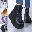 Black platform boots worn with colorful pants on a blurred background