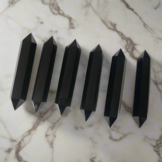 Set of black obsidian crystal points on a white background