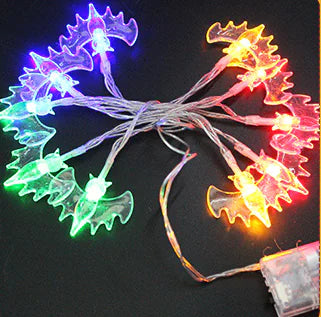 Colorful leaf-shaped LED string lights on a dark background