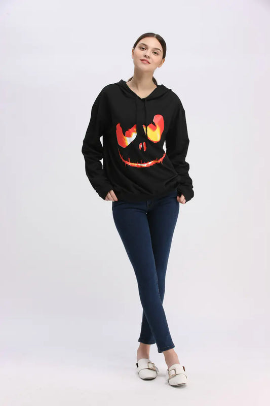 Person wearing a black hoodie with a Halloween-themed design on a white background