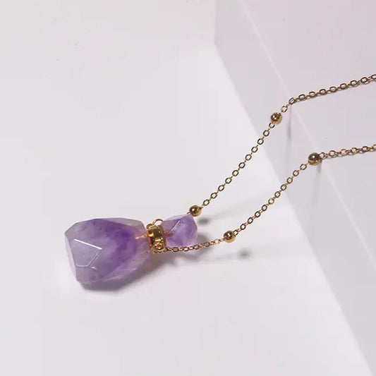 Necklace with purple crystal pendant on a white background