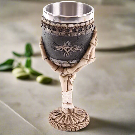 Decorative goblet with skeleton hand design on a white background