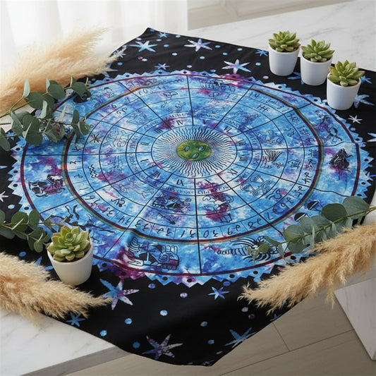 Person holding a colorful tapestry with astrological symbols by a poolside.