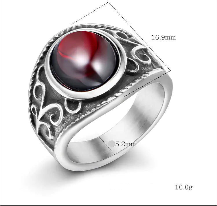 Silver ring with a red gemstone and measurements on a white background