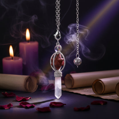 Jewelry pendant with red stone and clear crystal on a black background